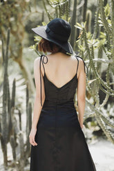 Silk slip dress with adjustable tie straps and deep neckline in lightweight satin finish